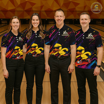 Four people standing together in a bowling alley wearing matching black short-sleeve bowling shirts with a colorful cosmic pattern and a large yellow duck graphic on the front, paired with black pants.