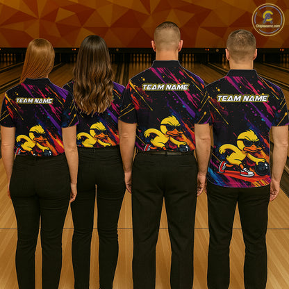 Four people standing from the back in a bowling alley, wearing matching custom bowling shirts with a colorful duck graphic and 'TEAM NAME' text on the back.