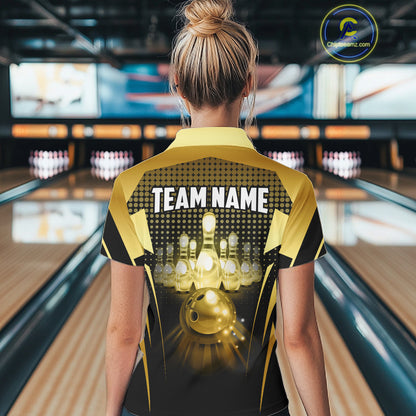 Female model wearing a custom black gold bowling quarter-zip shirt back view displaying the personalized team name above a glowing bowling ball and illuminated bowling pins graphic at the bowling alley