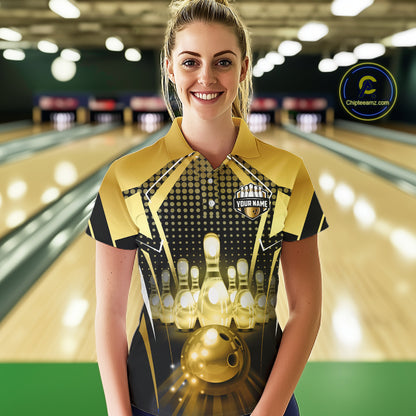 Female model wearing a custom black gold bowling polo shirt front view featuring a glowing bowling ball, illuminated bowling pins and gold geometric light beam pattern at the bowling alley