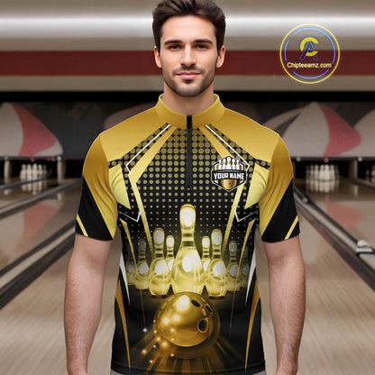 Male model wearing a custom black gold bowling quarter-zip shirt front view featuring a glowing bowling ball, illuminated bowling pins and gold geometric light beam pattern at the bowling alley