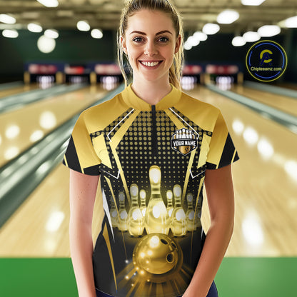 Male model wearing a custom black gold bowling quarter-zip shirt front view featuring a glowing bowling ball, illuminated bowling pins and gold geometric light beam pattern at the bowling alley