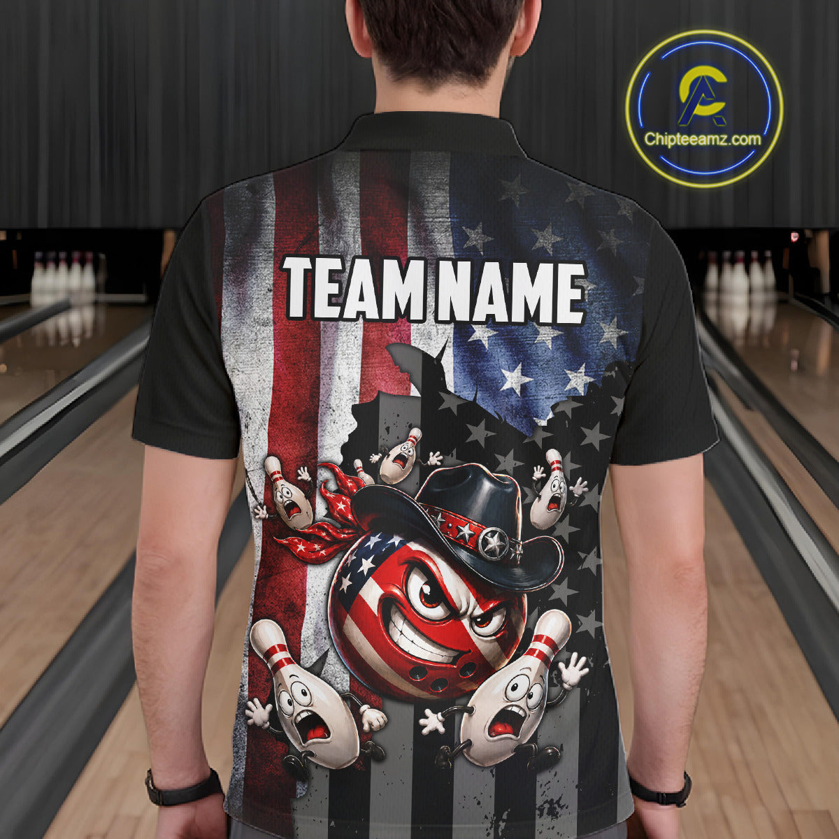 Person wearing a black bowling shirt with American flag design and 'TEAM NAME' text in a bowling alley.