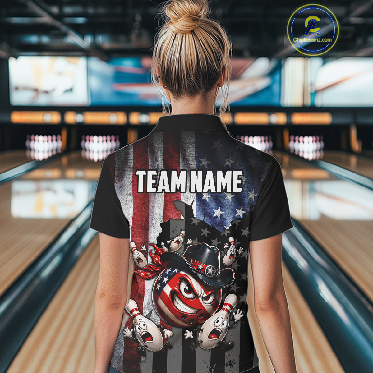 Person wearing a bowling shirt with a team name design in a bowling alley.