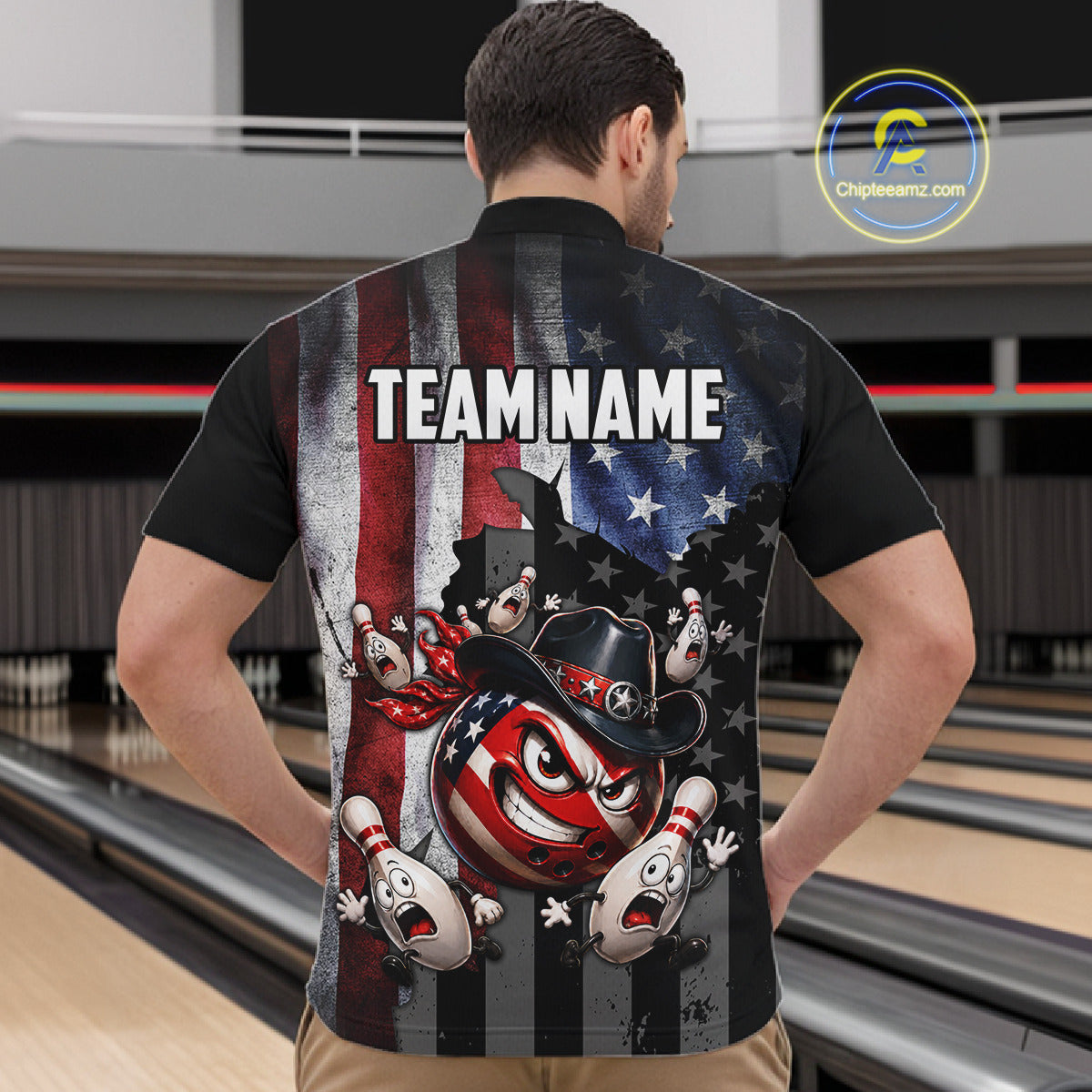 Person wearing a bowling-themed shirt with an American flag design in a bowling alley.