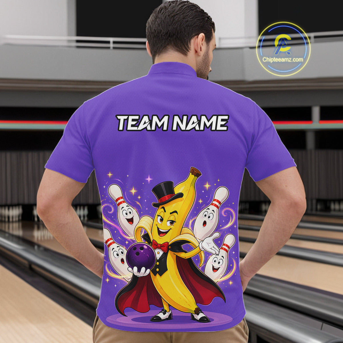 Person wearing a purple bowling-themed shirt with cartoon characters in a bowling alley.