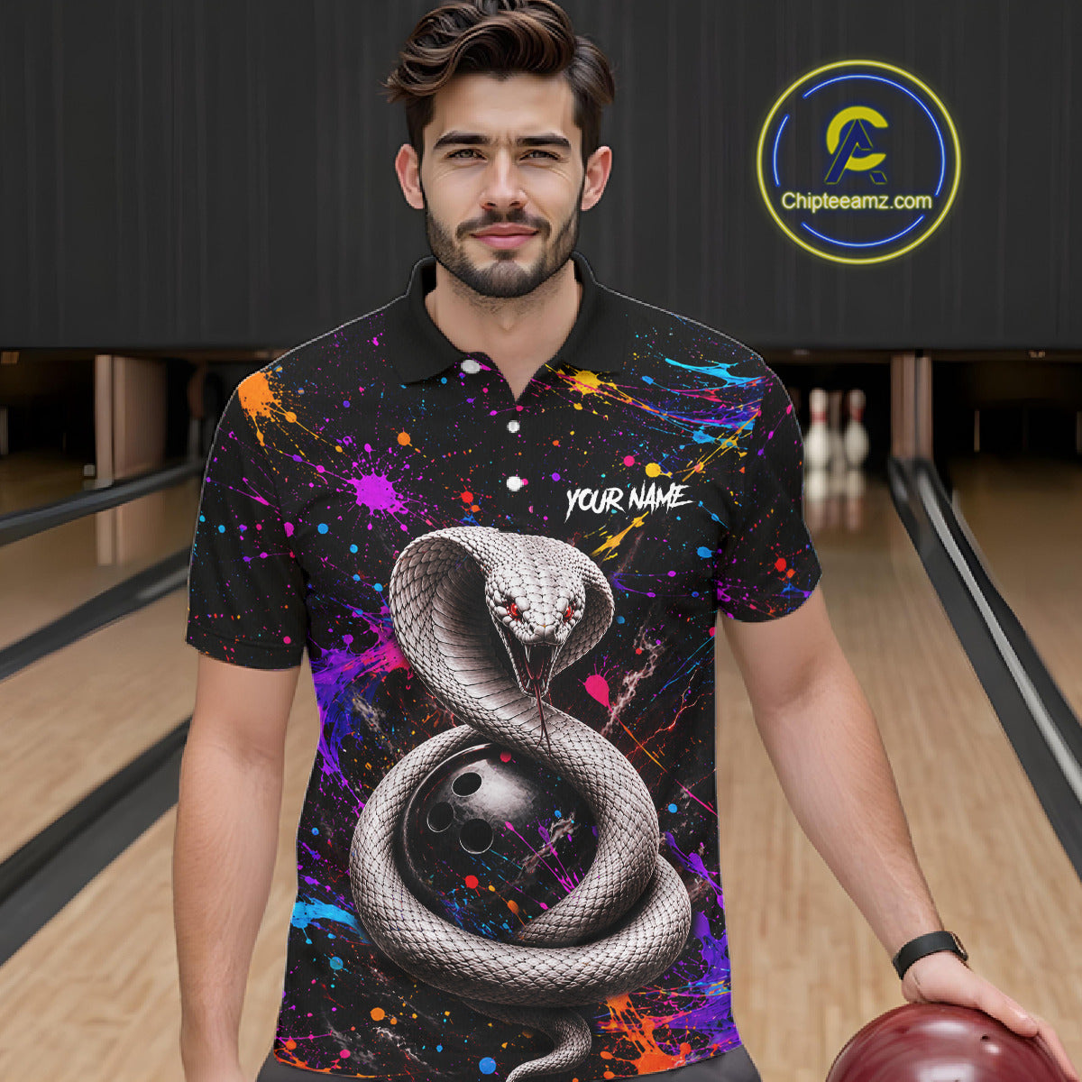 Man wearing a colorful polo shirt with a snake design in a bowling alley.