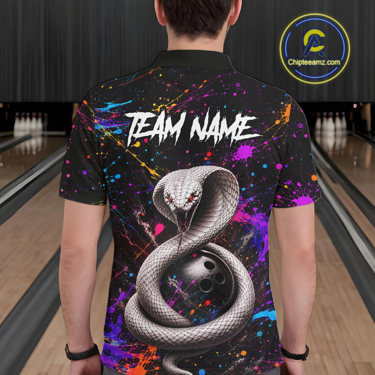 Person wearing a colorful bowling shirt with a snake design in a bowling alley.