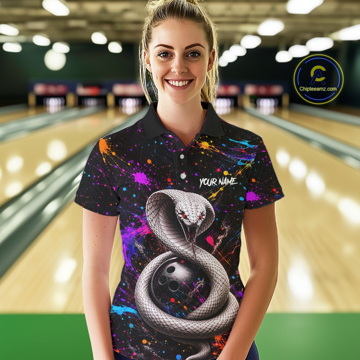 Woman wearing a colorful bowling shirt with a snake design in a bowling alley.