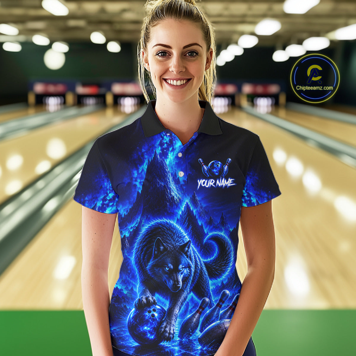 Woman wearing a blue wolf-themed bowling shirt in a bowling alley.