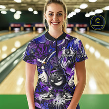Load image into Gallery viewer, Woman wearing a purple and black bowling shirt with a bowling alley in the background