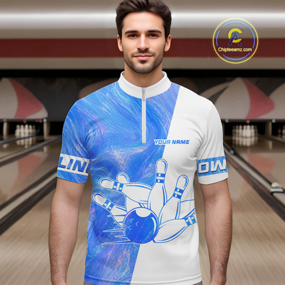 Man wearing a blue and white bowling-themed shirt in a bowling alley.