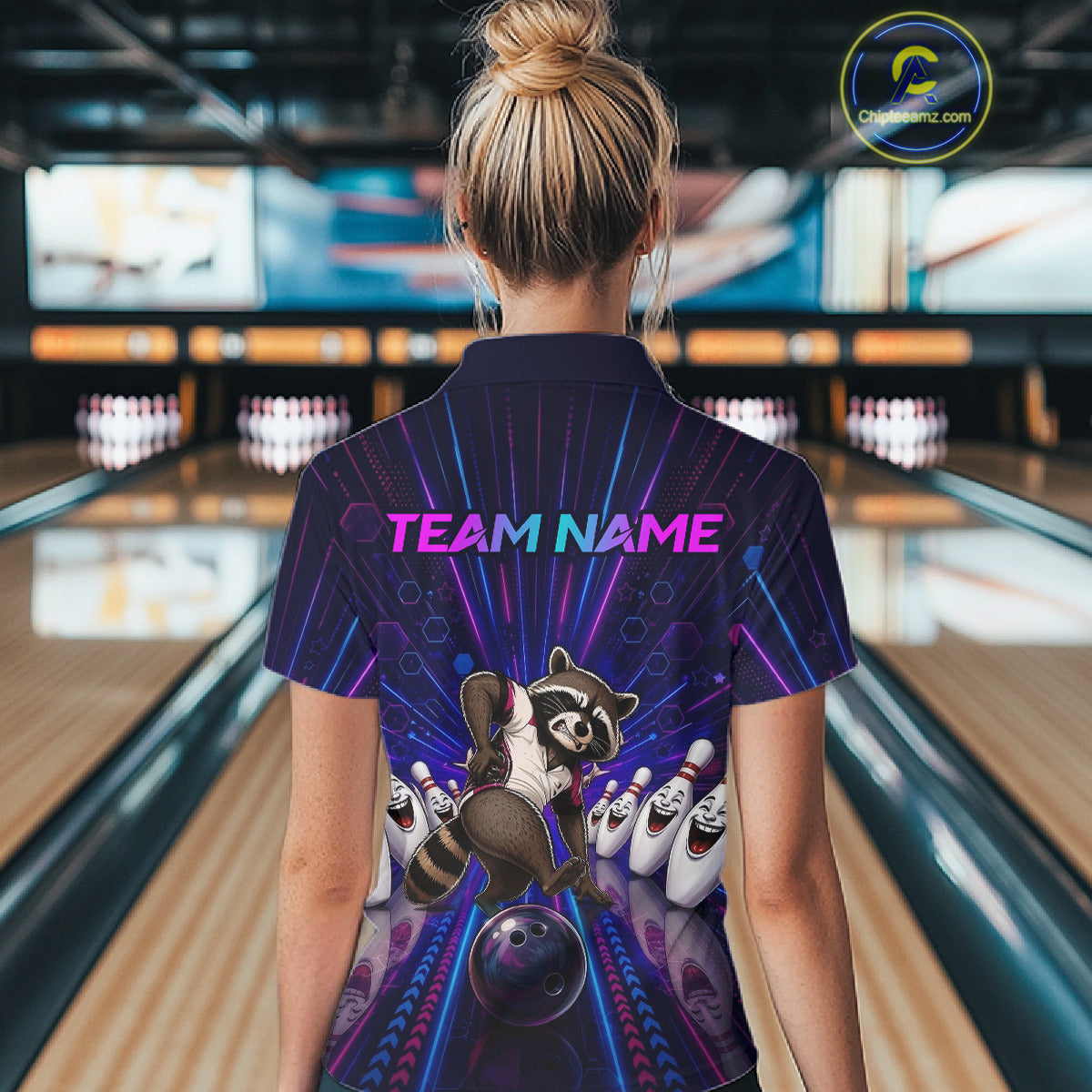 Person wearing a bowling-themed shirt with a raccoon design in a bowling alley.