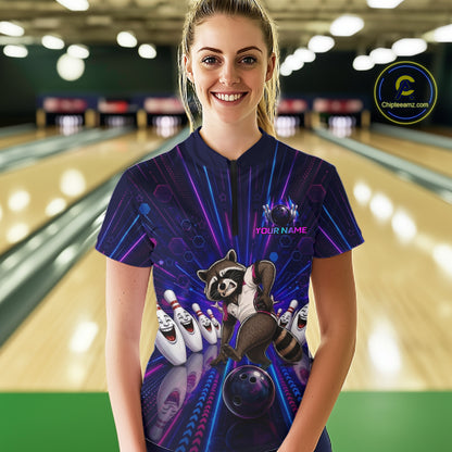 Person wearing a custom bowling shirt with a raccoon design in a bowling alley.