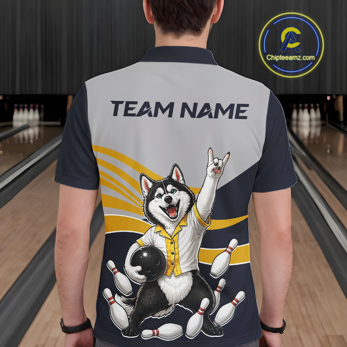 Person wearing a bowling-themed shirt with a dog graphic and 'Team Name' text in a bowling alley.