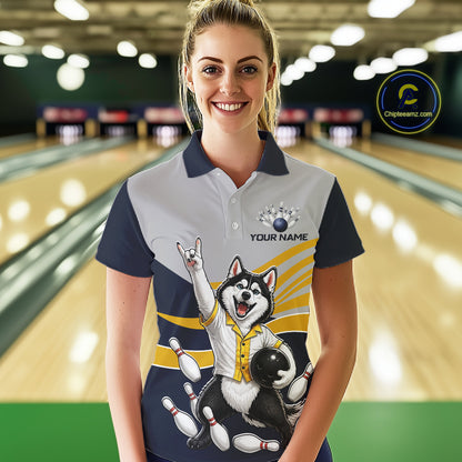 Person wearing a bowling-themed shirt with a dog graphic in a bowling alley.