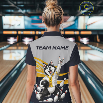 Person wearing a bowling shirt with a dog graphic and 'TEAM NAME' text in a bowling alley.