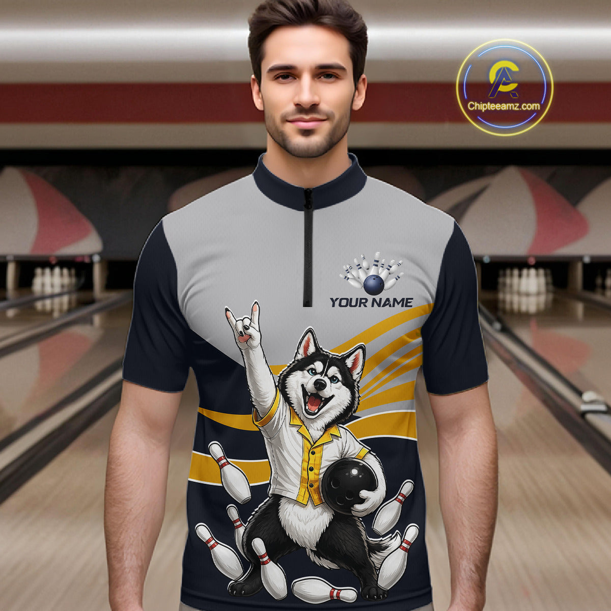 Man wearing a bowling-themed shirt with a dog design in a bowling alley.