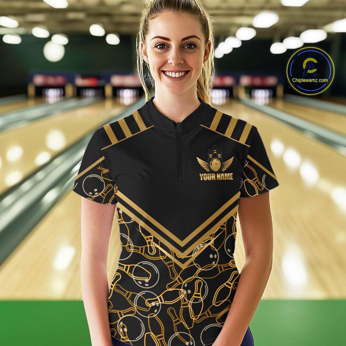 Female model wearing a custom black gold bowling quarter-zip shirt front view featuring a golden winged bowling ball emblem, geometric line pattern and premium black gold design at the bowling alley