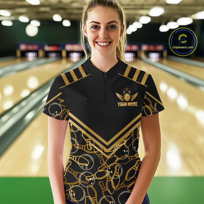 Female model wearing a custom black gold bowling quarter-zip shirt front view featuring a golden winged bowling ball emblem, geometric line pattern and premium black gold design at the bowling alley