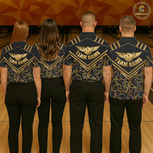 Load image into Gallery viewer, Group of four wearing custom black gold bowling shirts back view displaying personalized team names above golden winged bowling ball artwork on a black gold geometric pattern background at the bowling alley