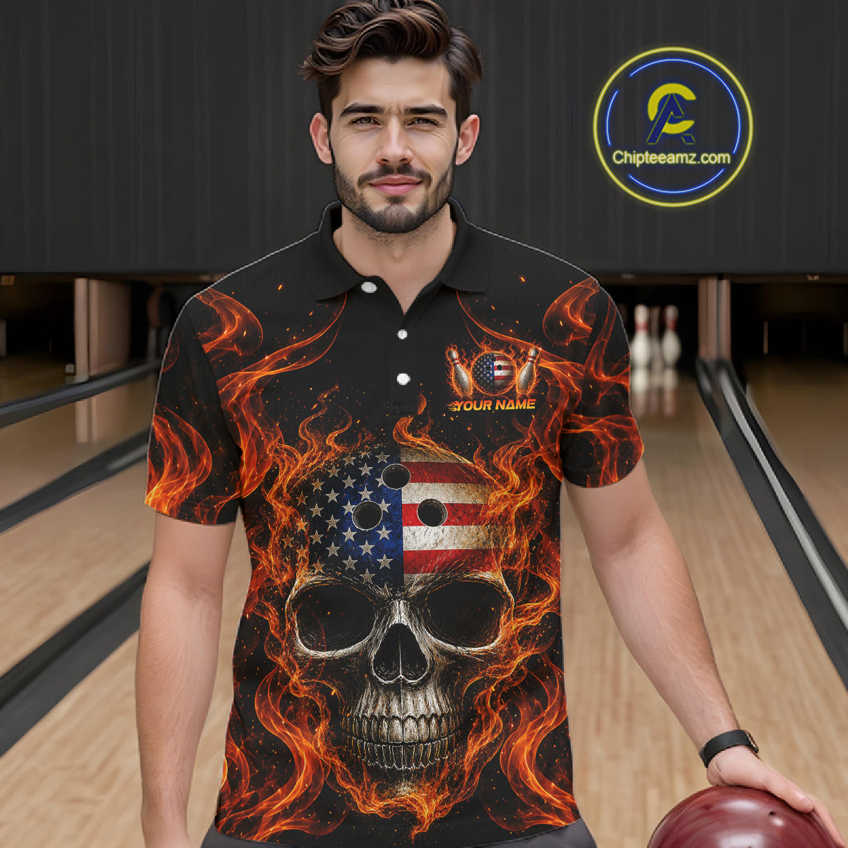 Man wearing a black polo shirt with a skull and flames design in a bowling alley.