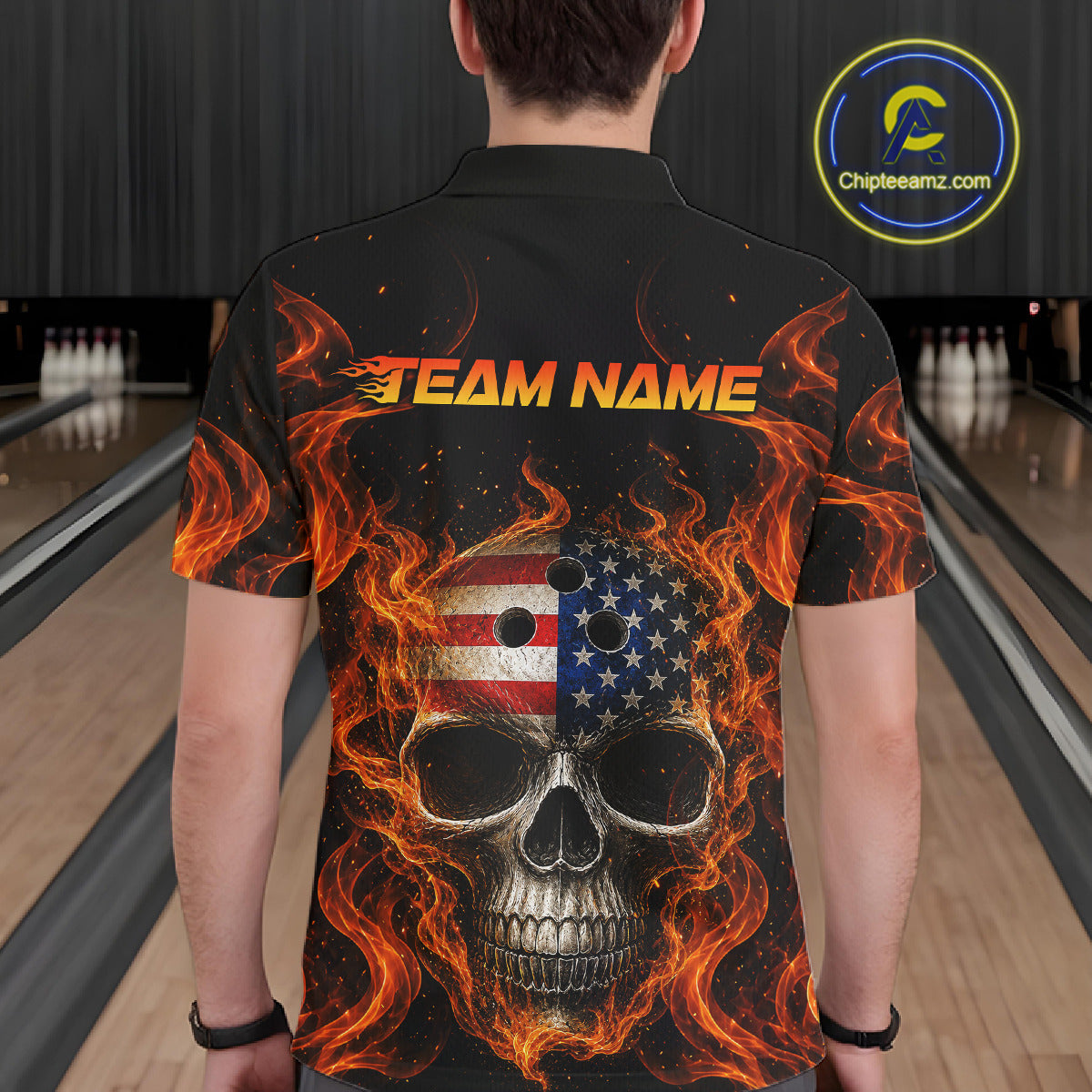 Person wearing a black bowling shirt with a fiery skull design and 'TEAM NAME' text at a bowling alley.