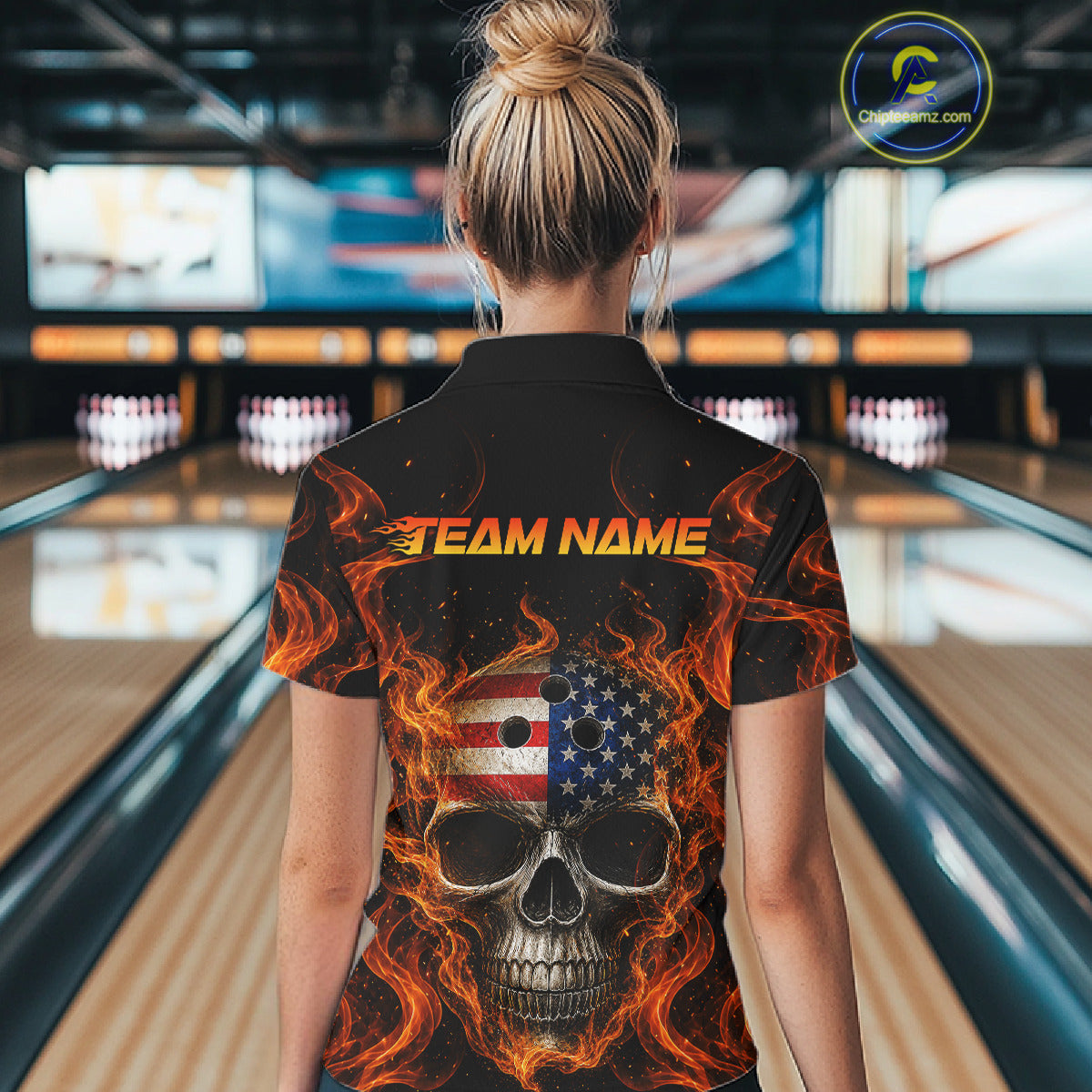 Person wearing a black shirt with a skull design and 'Team Name' text in a bowling alley.