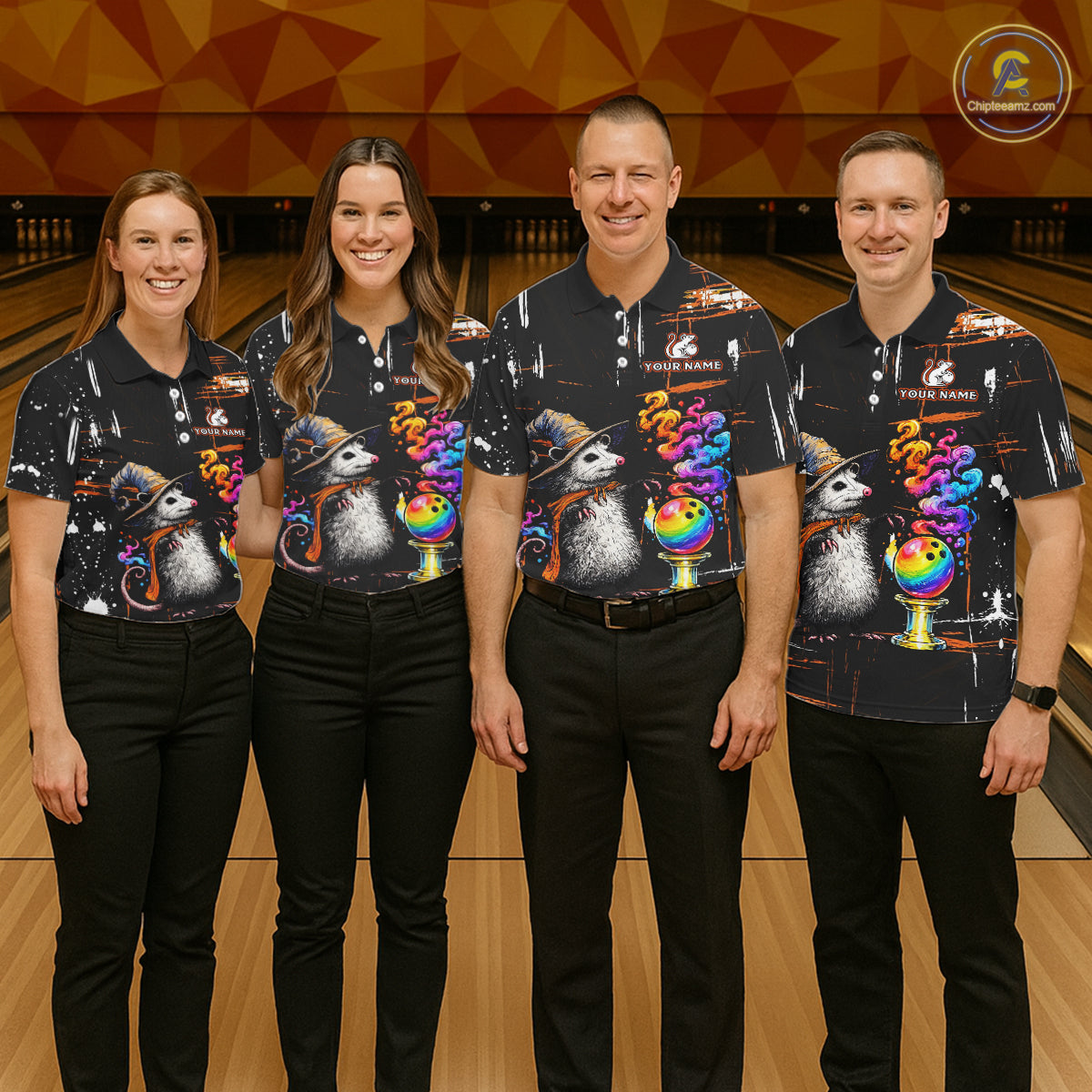 Four people standing together in a bowling alley wearing matching black short-sleeve bowling shirts with a colorful opossum and rainbow bowling graphic, paired with black pants.