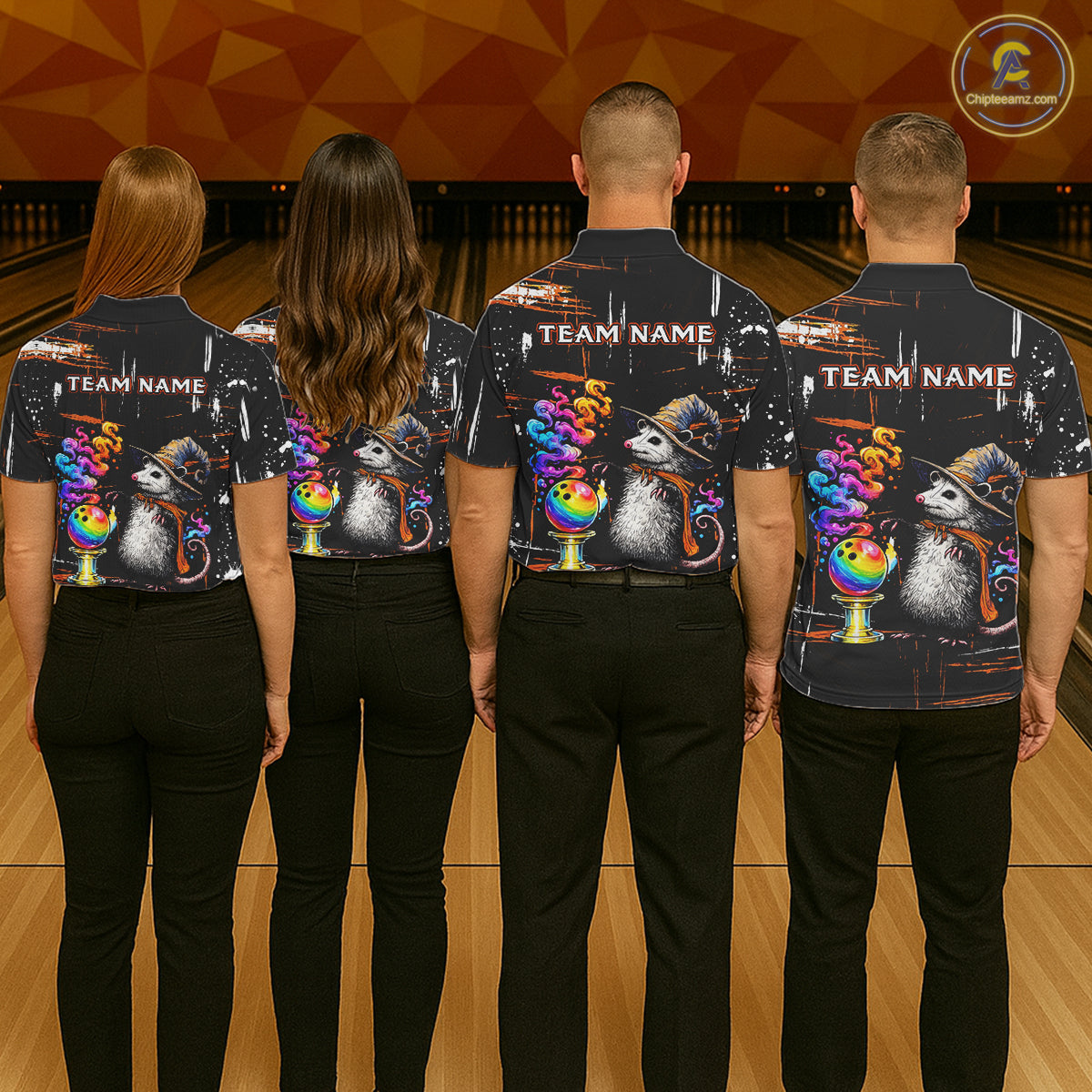 Four people standing with their backs to the camera in a bowling alley, wearing matching dark short-sleeve shirts with a colorful graphic print of opossum wearing hats and rainbow bowls, plus 'TEAM NAME' text on the back.