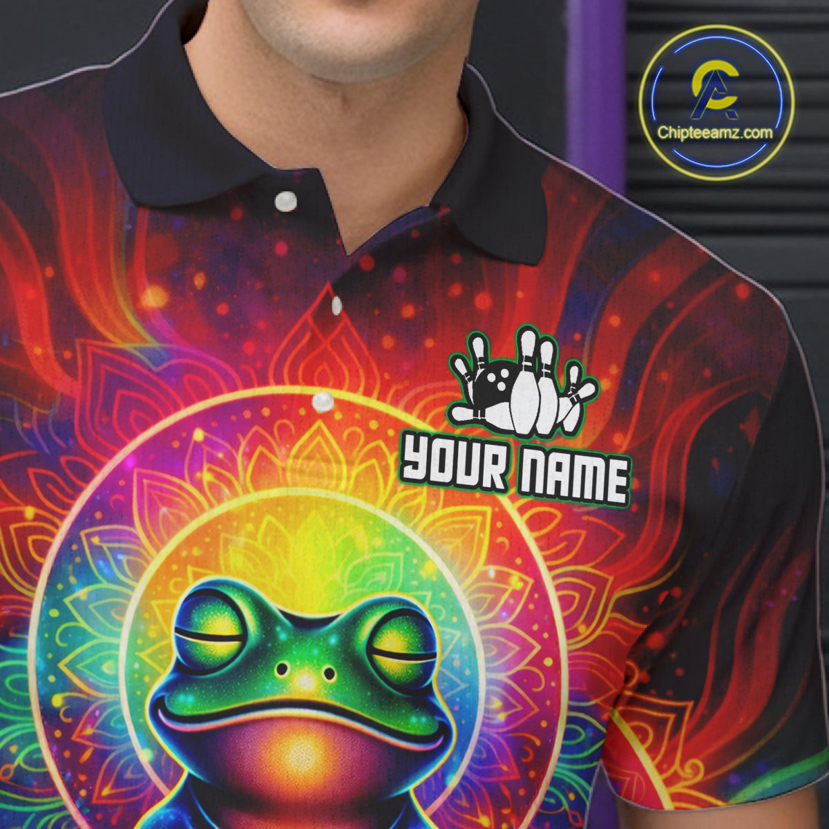 Close-up front view of a custom zen frog bowling polo shirt showing the personalized player name, vibrant neon frog graphic and colorful psychedelic cosmic design