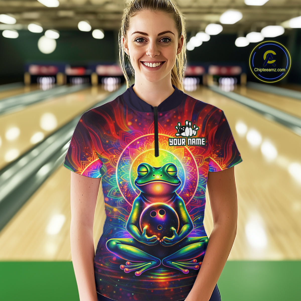 Female model wearing a custom zen frog bowling quarter-zip shirt front view featuring a vibrant neon frog, bowling ball, glowing cosmic background and colorful psychedelic pattern at the bowling alley