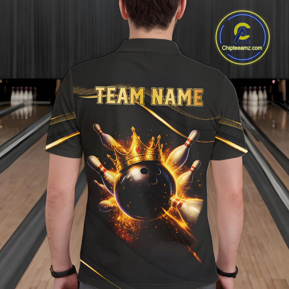 Man wearing custom black gold bowling polo shirt back view featuring a fiery bowling ball and flame burst effect, displaying Team Name, at the bowling alley