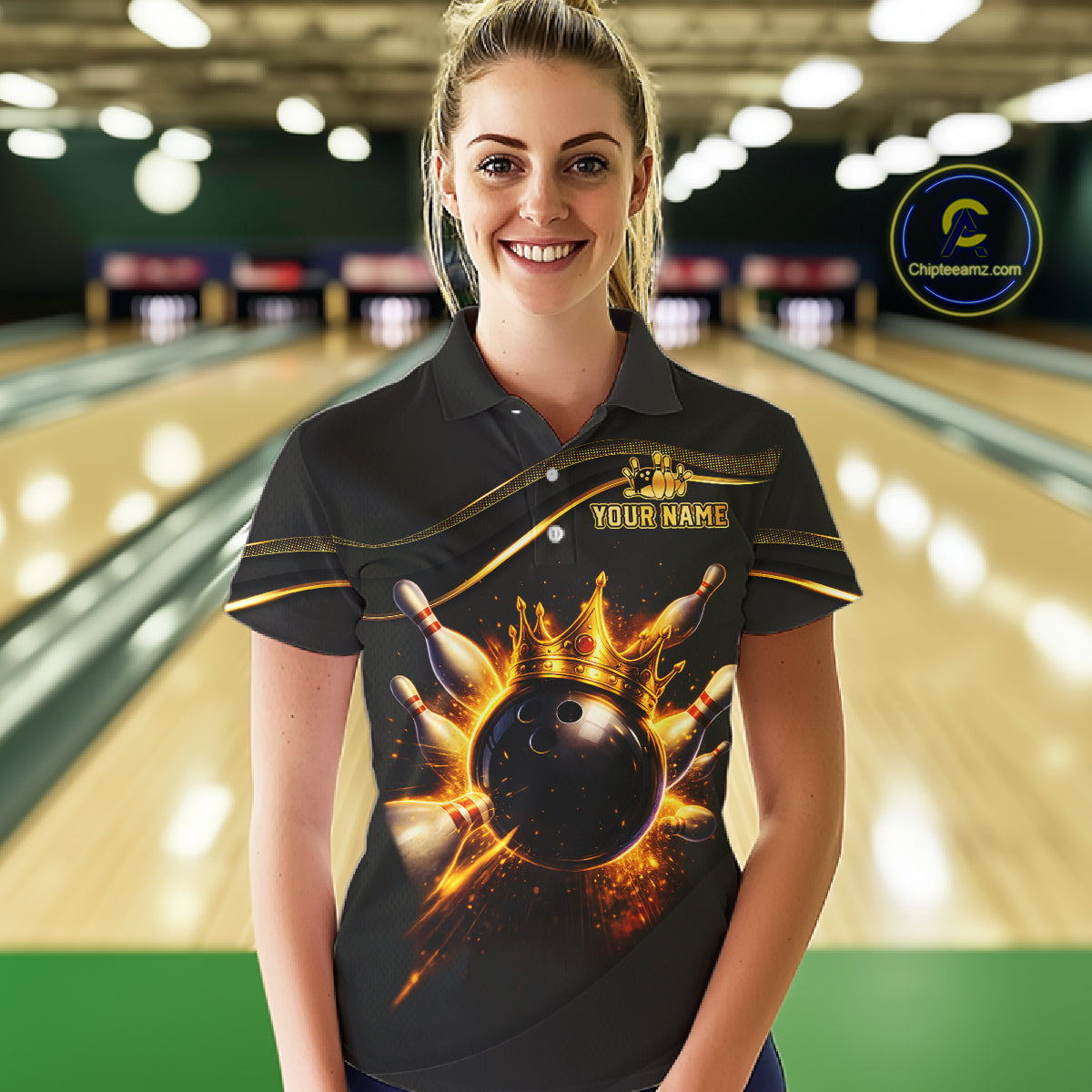 Woman wearing custom black gold bowling polo shirt front view featuring a fiery bowling ball and flame burst effect, displaying Your Name, at the bowling alley