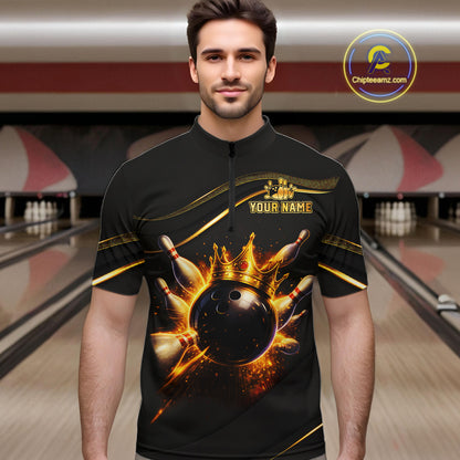Man wearing custom black gold bowling quarter-zip shirt front view featuring a fiery bowling ball and flame burst effect, displaying Your Name, at the bowling alley
