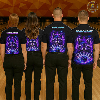 Four people standing in a bowling alley, viewed from behind, wearing black short-sleeve shirts with a custom graphic print of a raccoon and bowling ball in a purple and blue cosmic design. The shirts also feature 'TEAM NAME' text printed on the upper back.