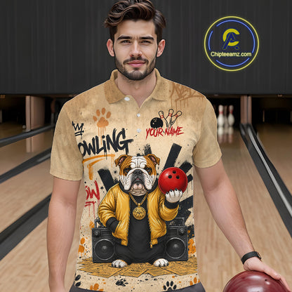 A man wearing a beige short-sleeve polo shirt with a detailed bowling-themed graphic print featuring an bulldog, bowling pins, and a red bowling ball. The background shows bowling lanes, and a 'Chipleamz.