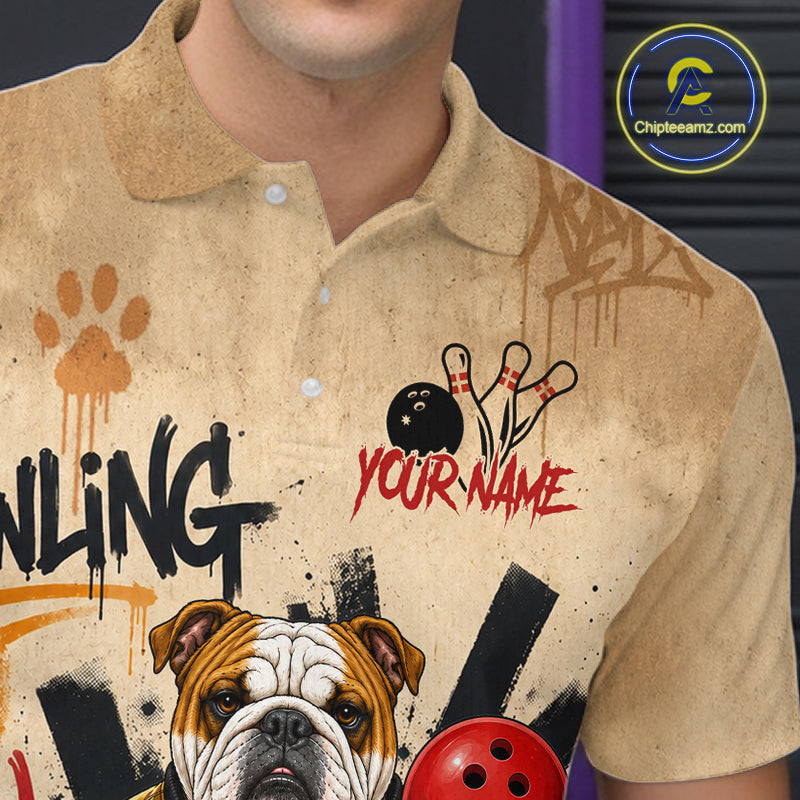 A close-up of a person wearing a beige short-sleeve polo shirt with bowling-themed graphics, including a bulldog illustration, bowling pins, a bowling ball, paint splatters, and the text 'YOUR NAME' and 'BOWLING'. A circular 'Chipeamz.