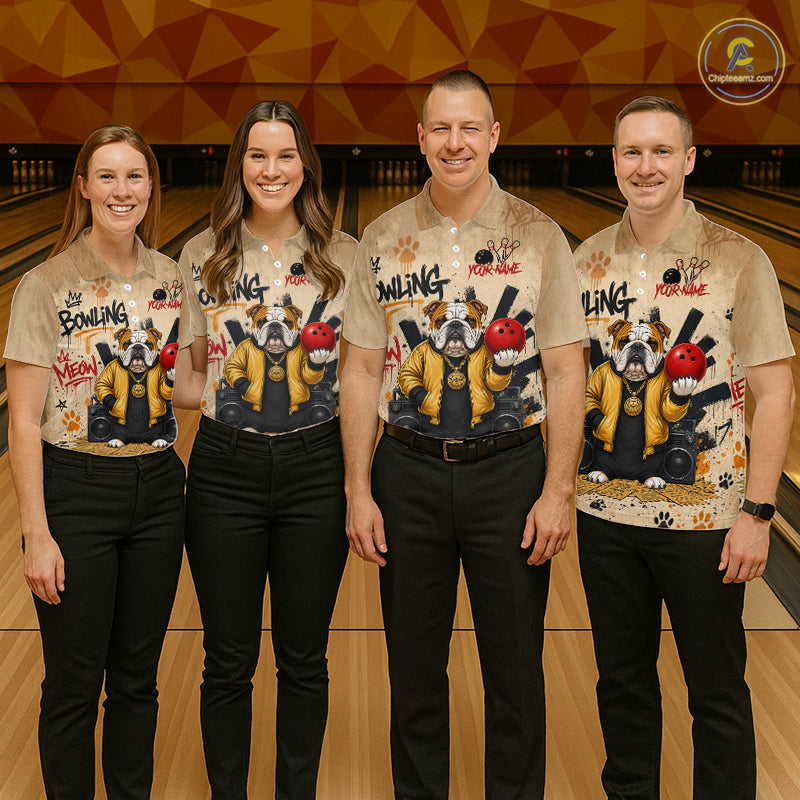 Four people standing together in a bowling alley wearing matching beige graphic bowling shirts with bulldog illustrations and black pants.