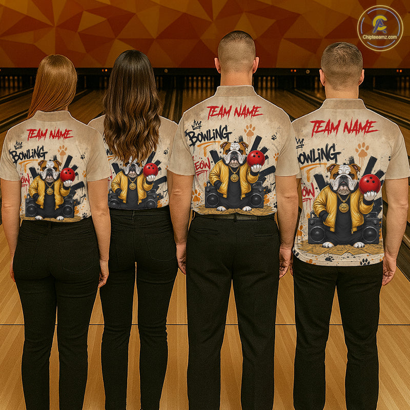 Four people standing in a bowling alley, viewed from behind, wearing matching beige short-sleeve button-up shirts with a large dog-themed bowling graphic and red 'TEAM NAME' text on the back, paired with black pants.