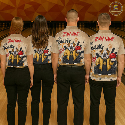 Four people standing in a bowling alley, viewed from behind, wearing matching beige short-sleeve button-up shirts with a large dog-themed bowling graphic and red 'TEAM NAME' text on the back, paired with black pants.