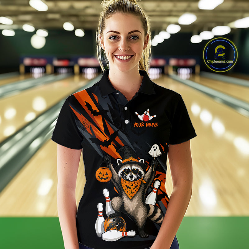 Women wearing a black Halloween bowling polo featuring a raccoon wearing an orange bandana, ghost and pumpkin accents, bowling pins and ball, with personalized name and team name text.