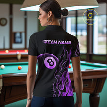 Load image into Gallery viewer, Women wearing billiards polo shirt featuring an eight ball design surrounded by flowing purple flame graphics on a black background.