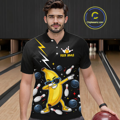 Man wearing a black polo with a banana character and bowling design in a bowling alley.