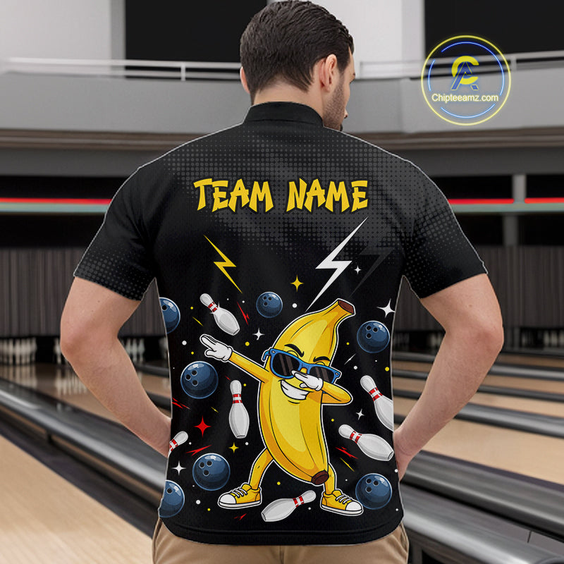 Man wearing a black bowling polo with a banana character and 'Team Name' text in a bowling alley.