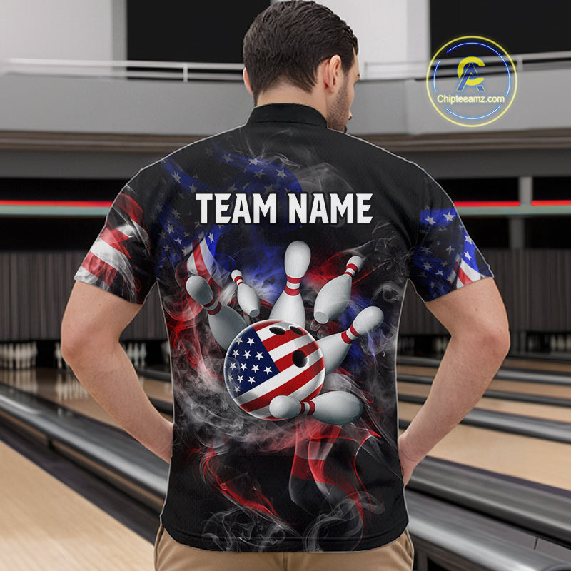 Man wearing a black bowling shirt with American flag design and 'TEAM NAME' text at a bowling alley.