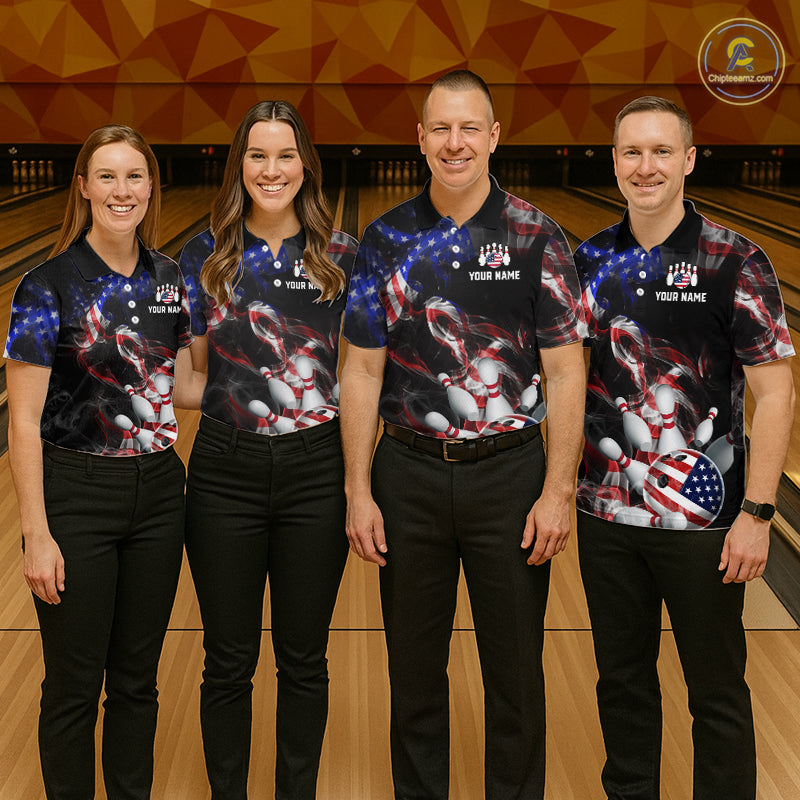 Four people wearing matching bowling shirts in a bowling alley.