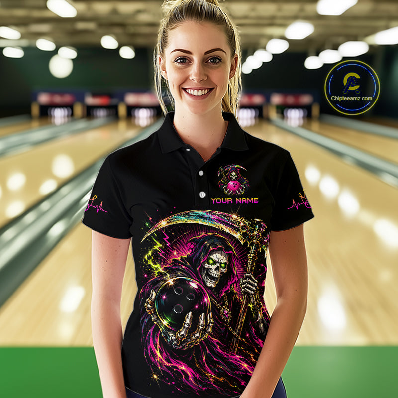 Woman wearing a black bowling shirt with colorful design in a bowling alley.