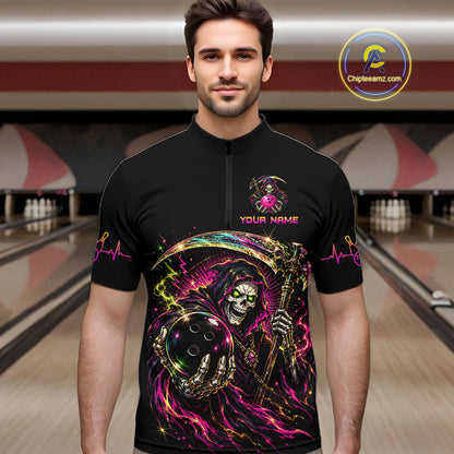 Man wearing a black shirt with colorful graphic design in a bowling alley.