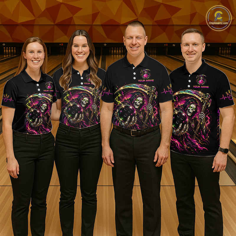Four people wearing matching black shirts with colorful designs in a bowling alley.